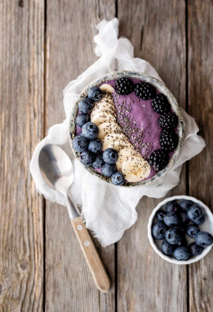 Bowl of soya yoghurt, blackberries and blueberries
