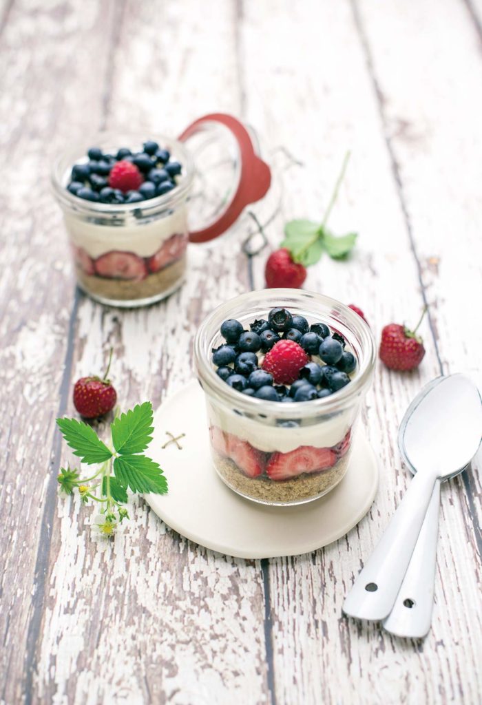 Cheesecake in a jar with blueberries, raspberries and strawberries